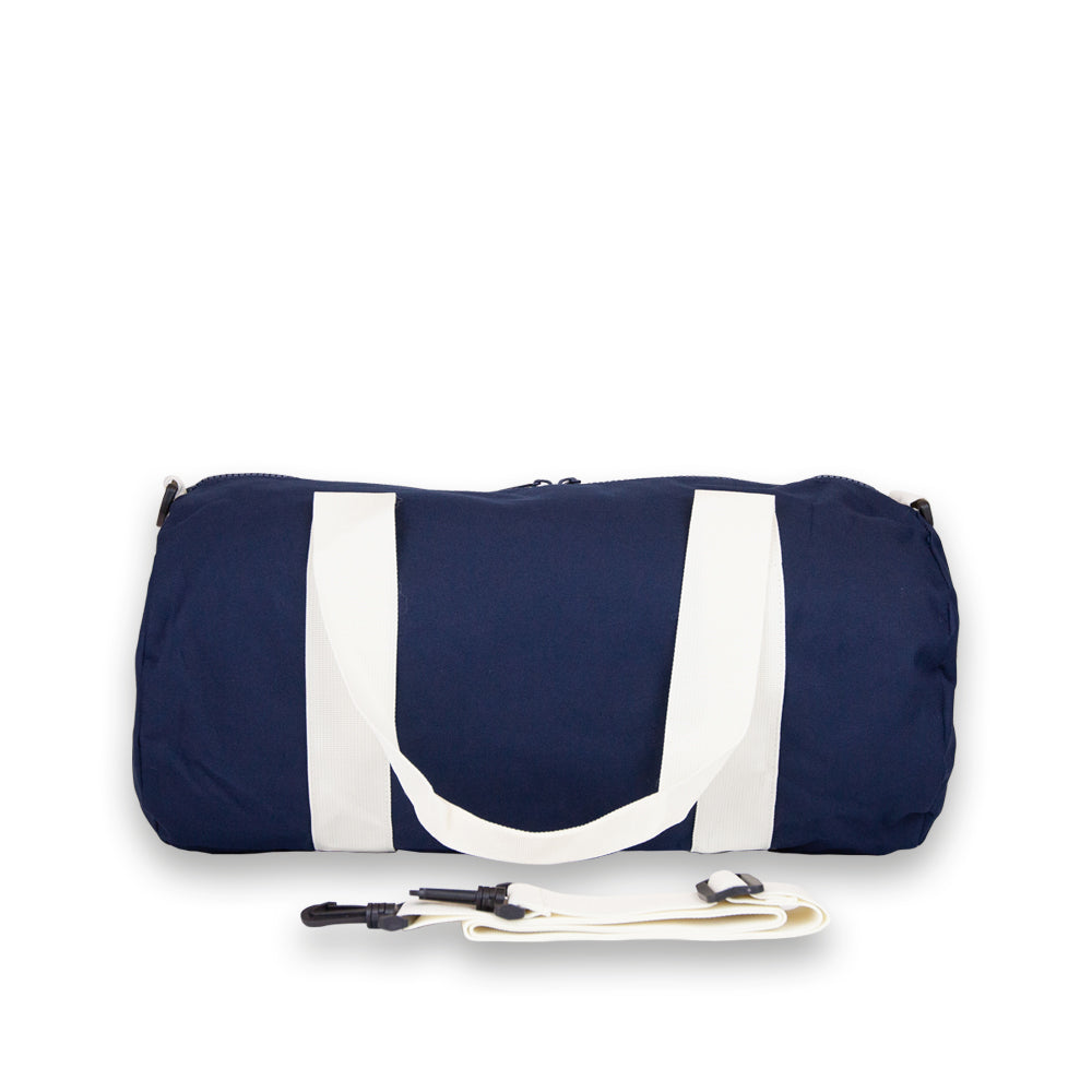 Duffel bag in navy. Rear view showing detachable shoulder strap.