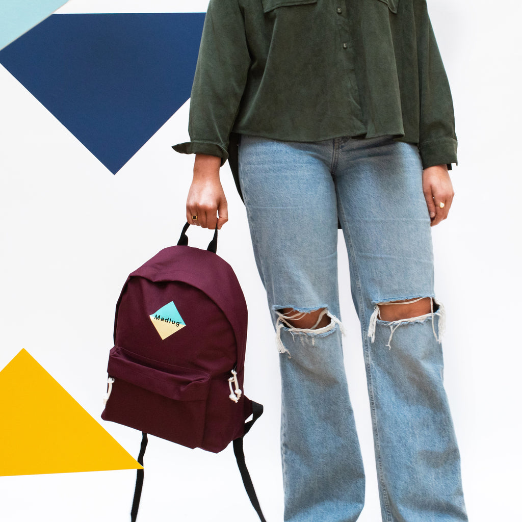 Madlug Classic Backpack in Burgundy. Female model side view.