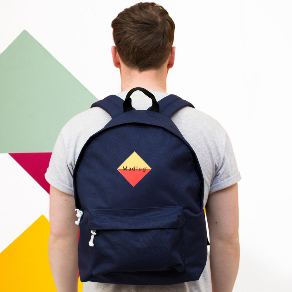 Madlug Classic Backpack in Navy. Male model side view.