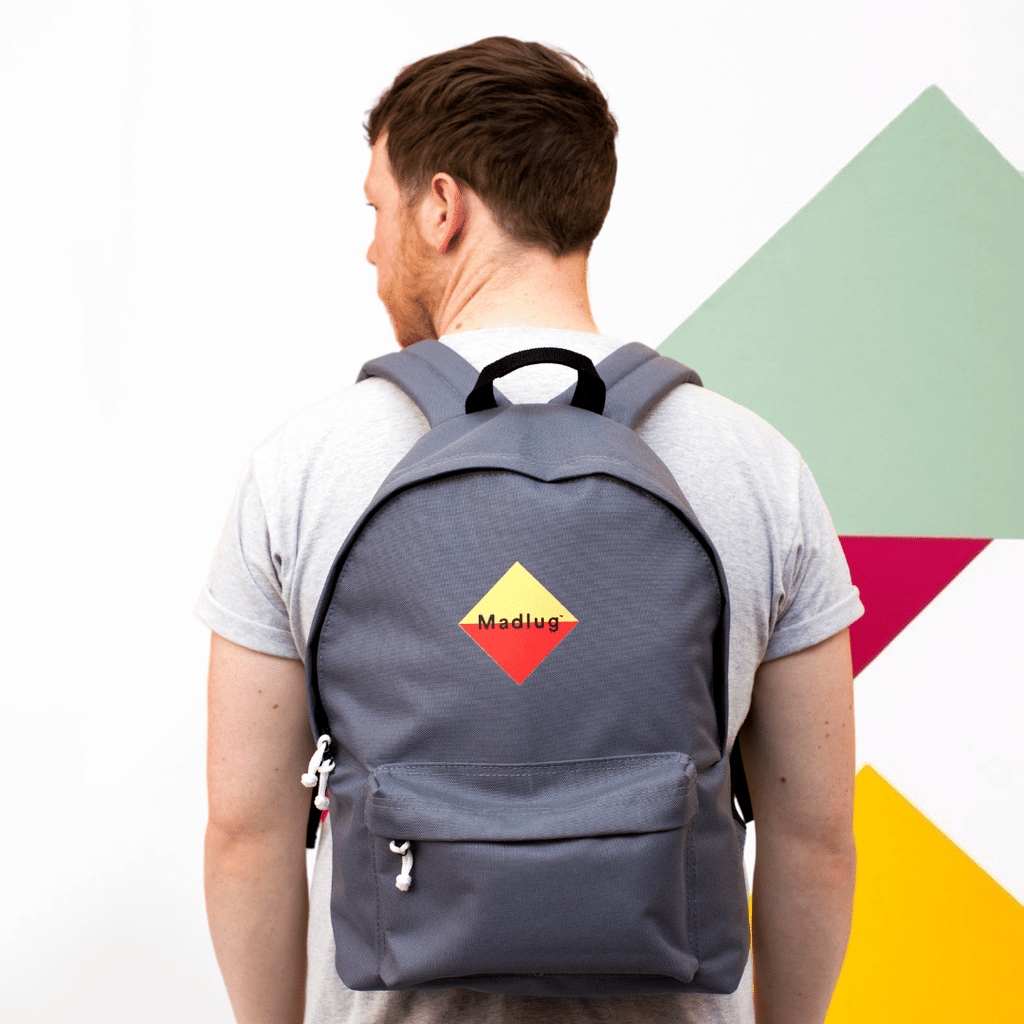 Madlug Classic Backpack in Grey. Male model rear view.
